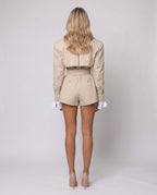 Women's beige belted trench-style playsuit with long sleeves and short legs