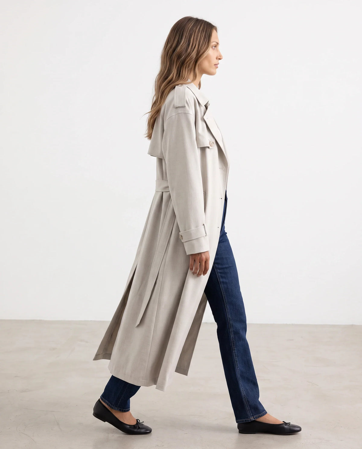Women's cream long trench coat with notched lapels and button front