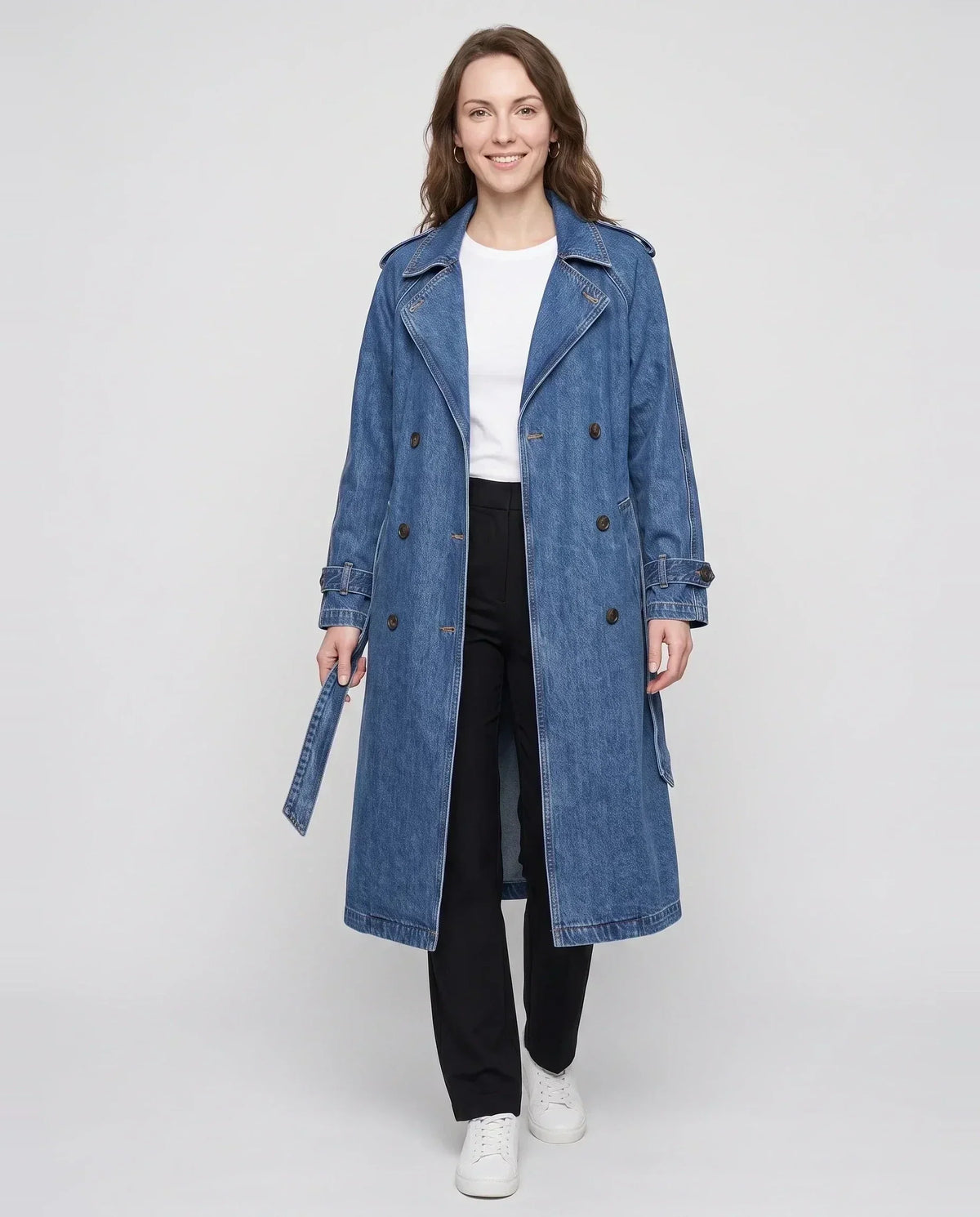 Women's long denim trench coat with lapels, buttons, belt and cuff straps