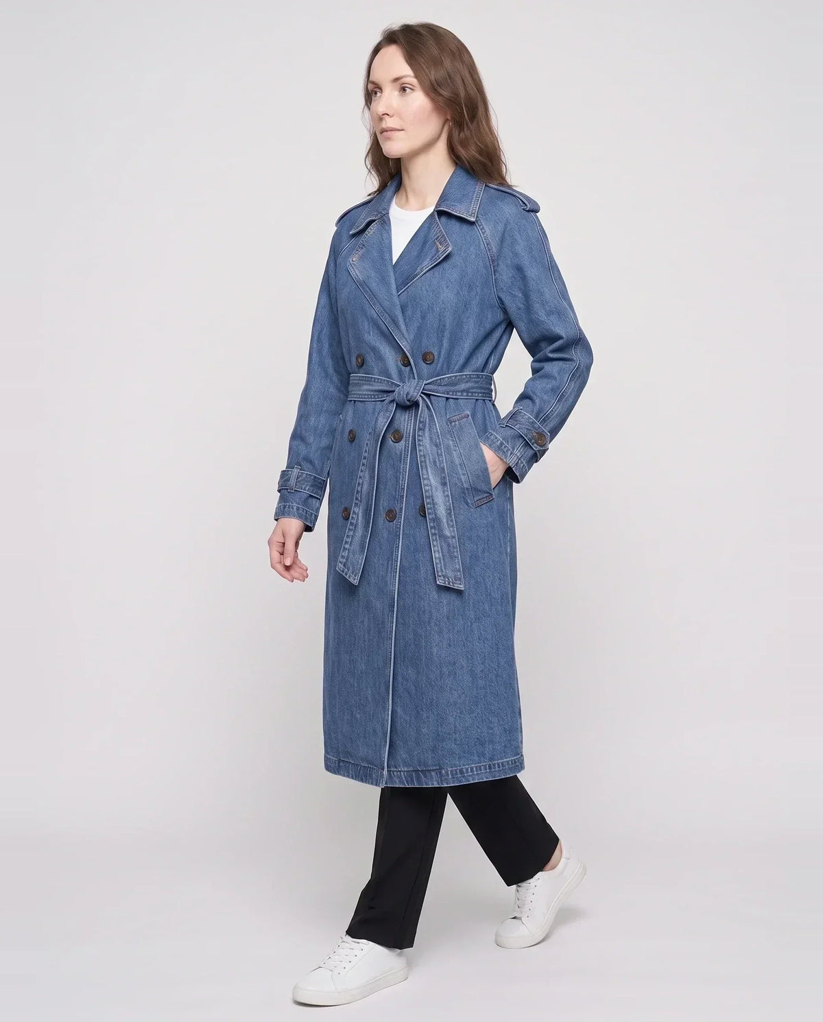 Women's long denim trench coat with lapels, buttons, belt and cuff straps