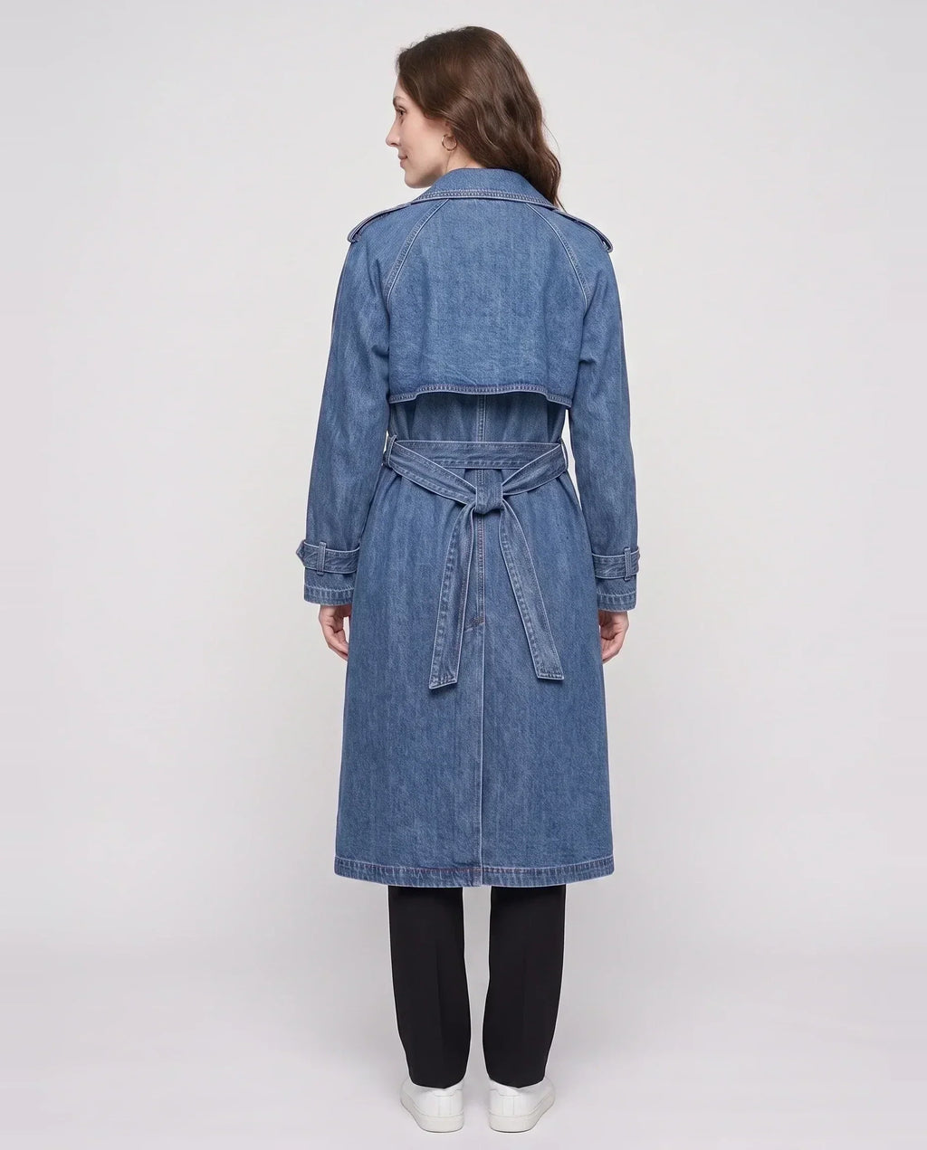 Women's long denim trench coat with lapels, buttons, belt and cuff straps