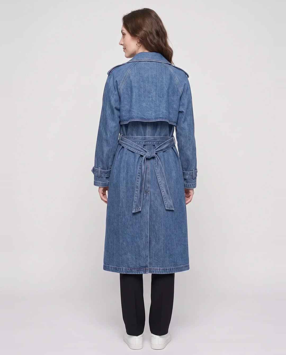 Women's long denim trench coat with lapels, buttons, belt and cuff straps