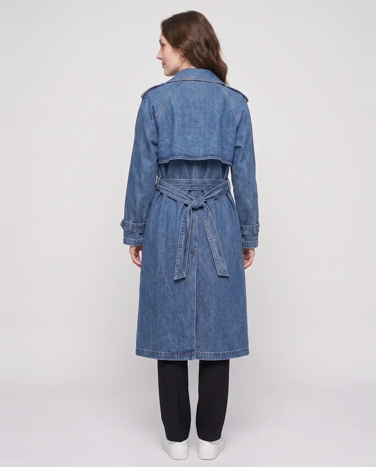 Women's long denim trench coat with lapels, buttons, belt and cuff straps