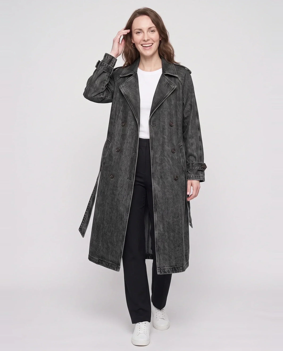 Women's long denim trench coat with lapels, buttons, belt and cuff straps