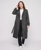Women's long denim trench coat with lapels, buttons, belt and cuff straps