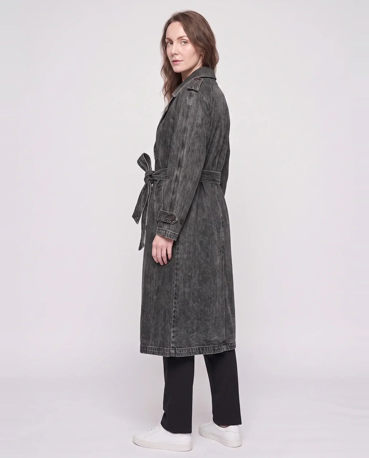 Women's long denim trench coat with lapels, buttons, belt and cuff straps