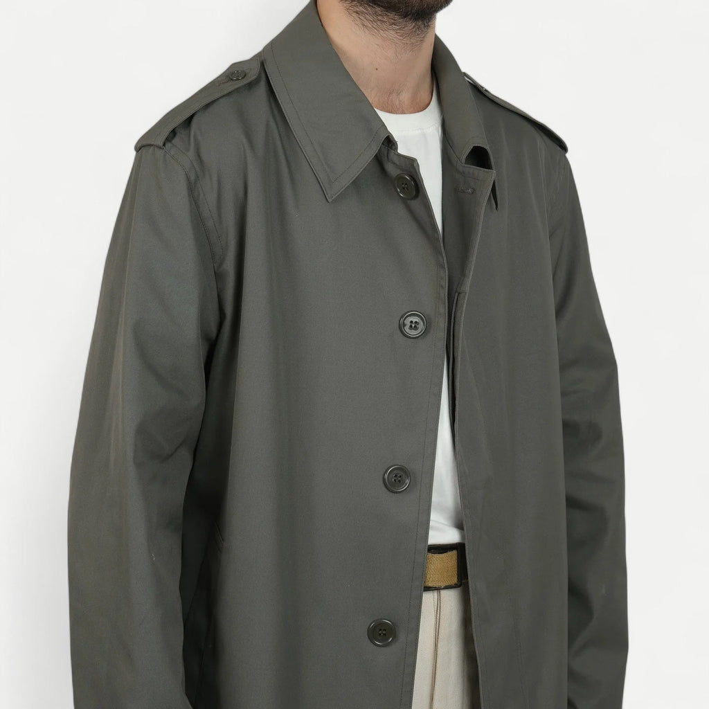 Men's muted green long raincoat with button front, pointed collar and shoulder tabs