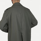 Men's muted green long raincoat with button front, pointed collar and shoulder tabs