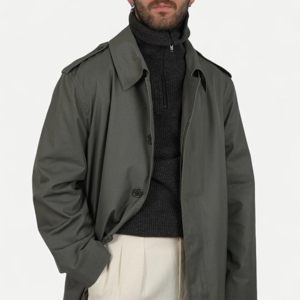 Men's muted green long raincoat with button front, pointed collar and shoulder tabs