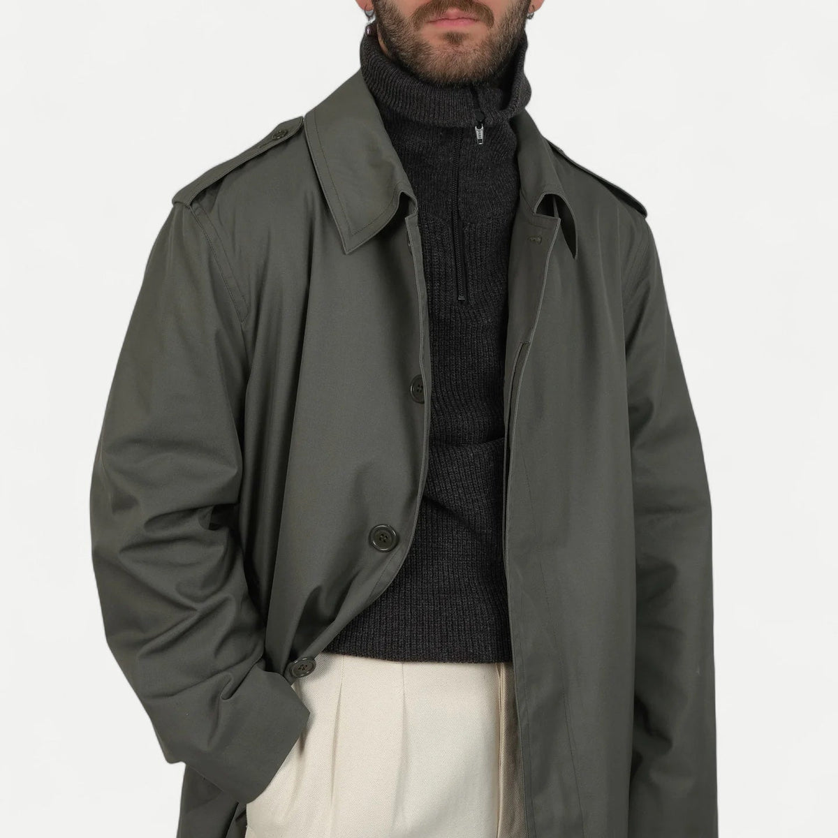 Men's muted green long raincoat with button front, pointed collar and shoulder tabs