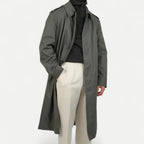 Men's muted green long raincoat with button front, pointed collar and shoulder tabs