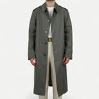 Men's muted green long raincoat with button front, pointed collar and shoulder tabs