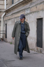 Men's muted green long raincoat with button front, pointed collar and shoulder tabs