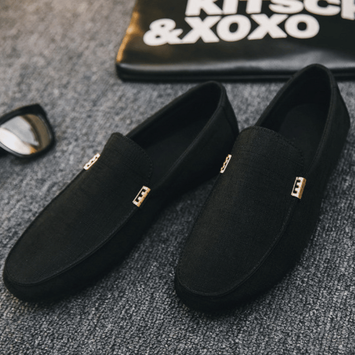 Men's slip-on loafers with gold-tone metal detail and flat sole