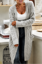 Women's longline hooded cable knit cardigan with long sleeves and front pockets