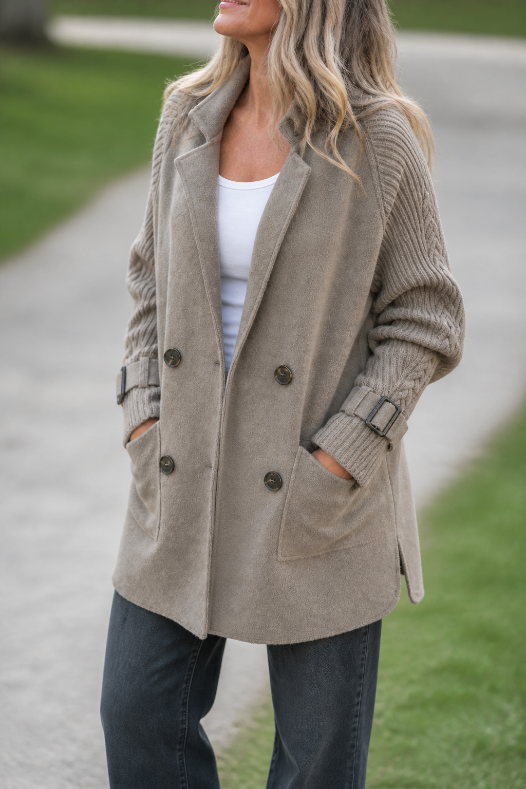 Women's longline double-breasted coat with knitted sleeves and buckle cuffs