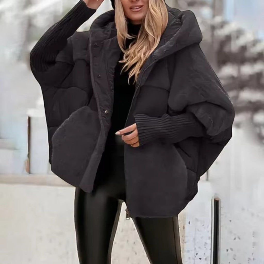 Women's oversized hooded quilted jacket with plush panels and ribbed cuffs