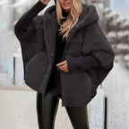 Women's oversized hooded quilted jacket with plush panels and ribbed cuffs