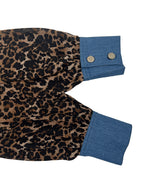 Women's leopard print blouse with blue contrast trim and long sleeves
