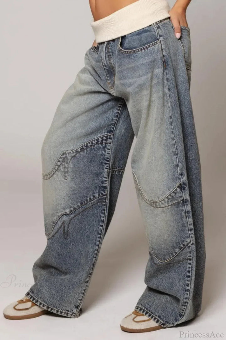 Women's washed blue wide-leg jeans with contrasting curved panel detailing