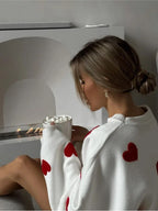 Women's knitted jumper with scattered contrasting motifs