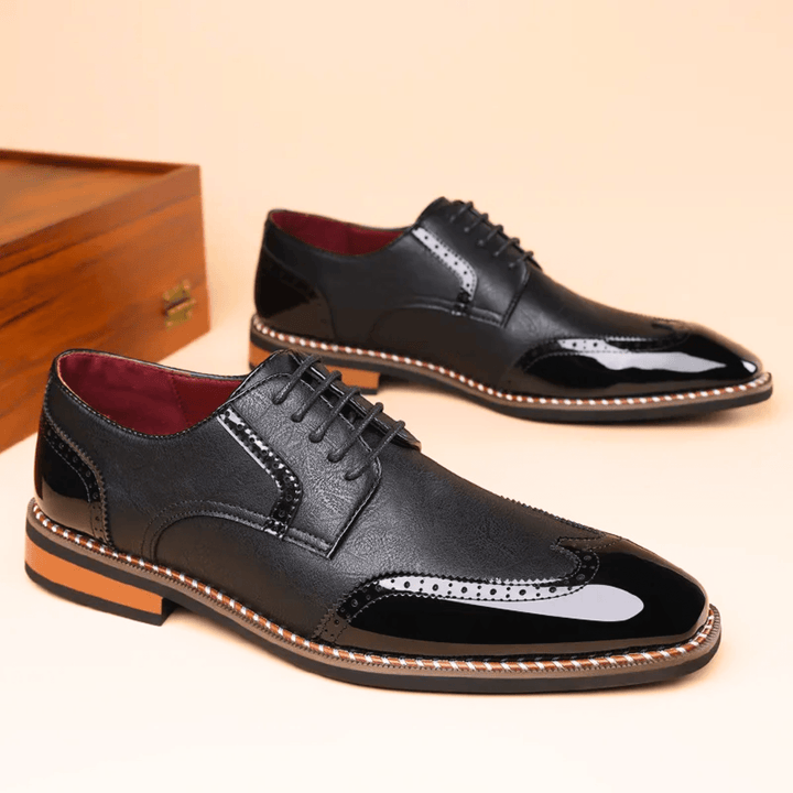 Men's brogue dress shoe with pointed toe, lace-up front and perforated panels