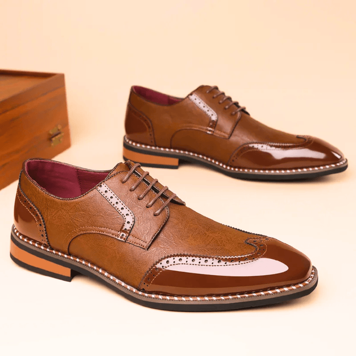 Men's brogue dress shoe with pointed toe, lace-up front and perforated panels