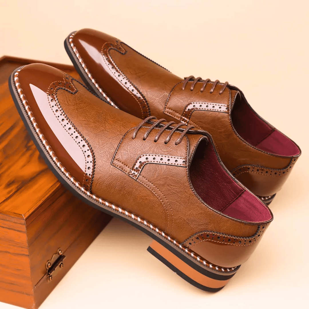 Men's brogue dress shoe with pointed toe, lace-up front and perforated panels
