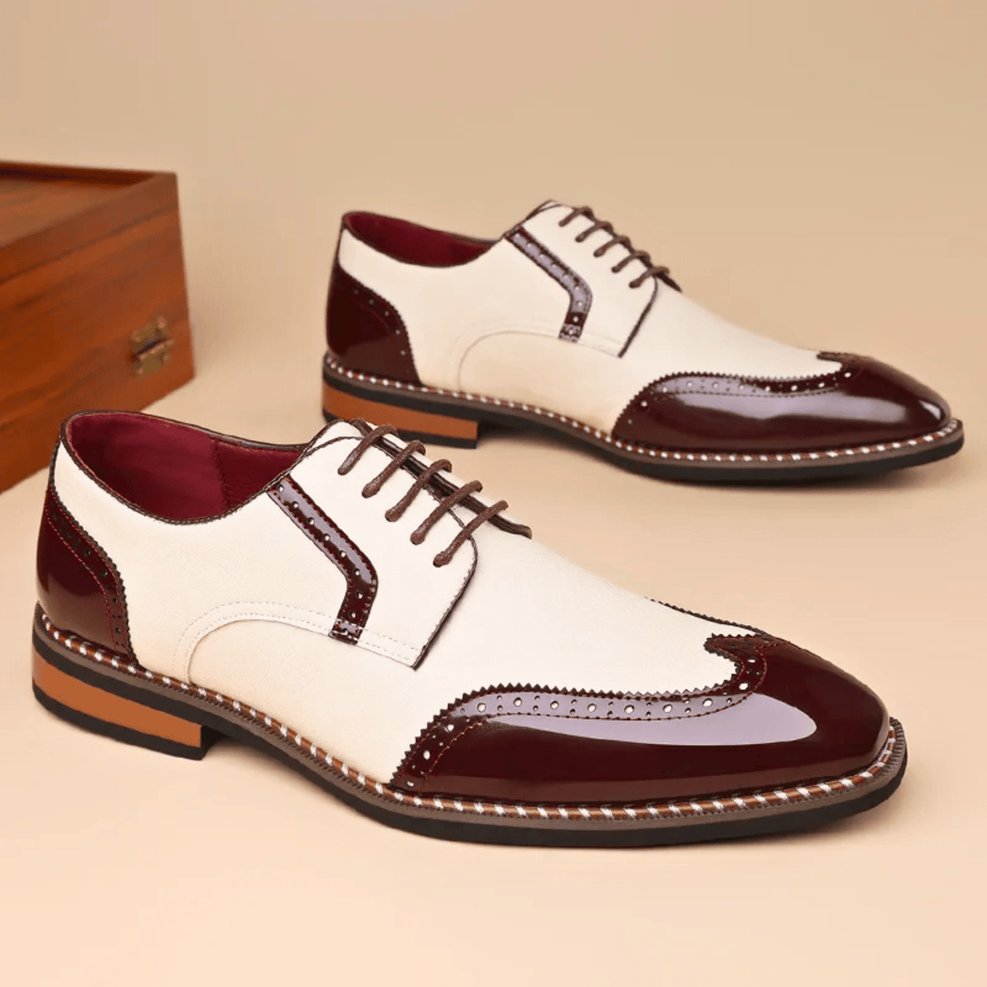 Men's brogue dress shoe with pointed toe, lace-up front and perforated panels