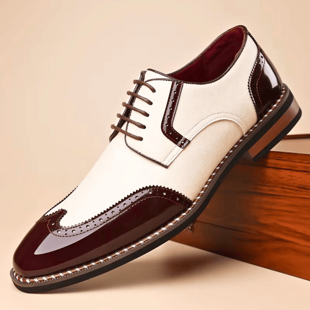 Men's brogue dress shoe with pointed toe, lace-up front and perforated panels