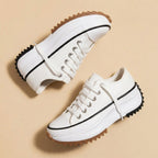 Women's platform sneakers with lace-up fronts, rounded toes and serrated soles