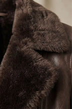 Women's brown shearling-lined jacket with wide dark collar and front zip