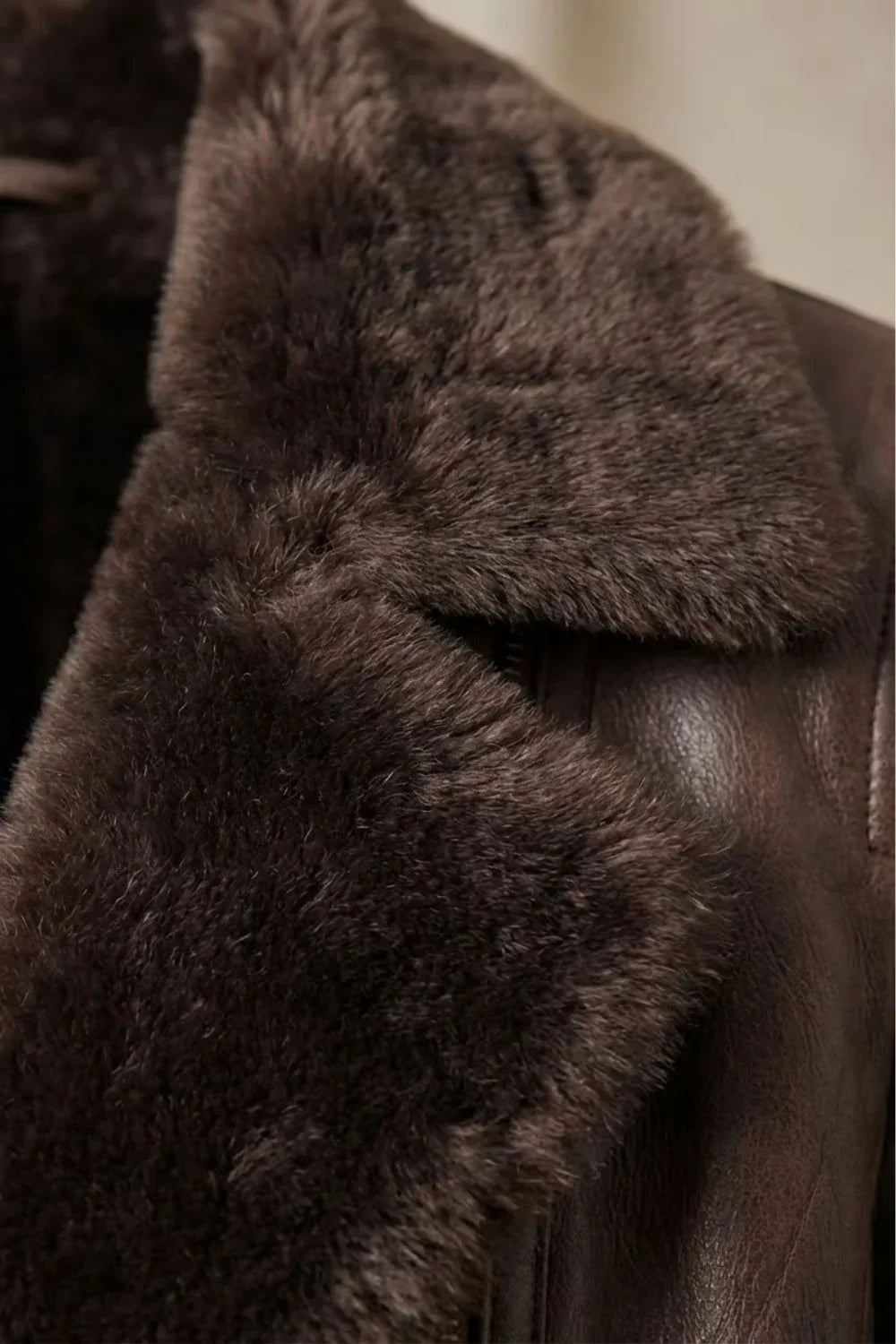 Women's brown shearling-lined jacket with wide dark collar and front zip