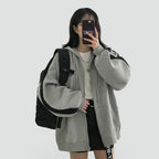 Women's relaxed hooded zip-front hoodie with long sleeves and front pockets