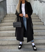 Women's long double-breasted belted coat with notched lapels and flap pockets