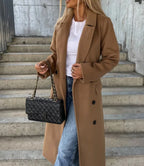 Women's long double-breasted belted coat with notched lapels and flap pockets