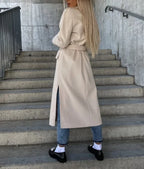 Women's long double-breasted belted coat with notched lapels and flap pockets