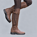 Women's tall riding boots with buckle strap, side zip and rugged tread sole