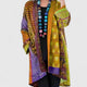 Women's open-front patchwork longline cardigan with patterned panels and long sleeves