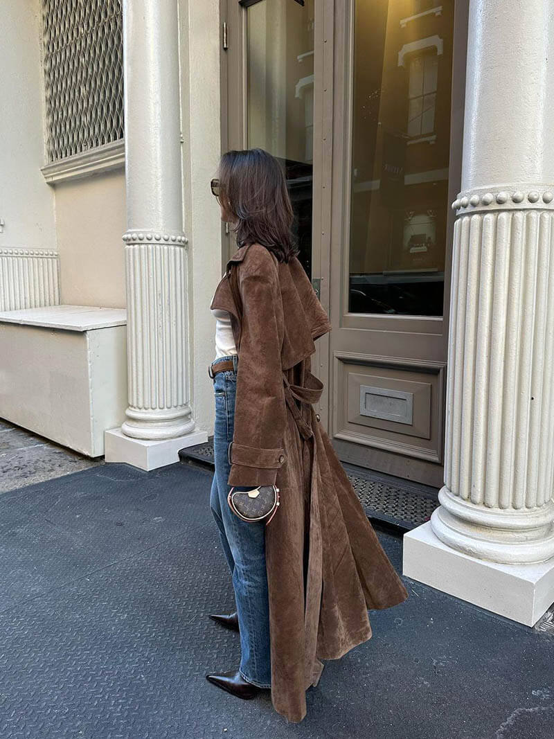 Women's long brown double-breasted trench coat with tie belt