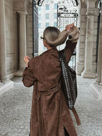 Women's long brown double-breasted trench coat with tie belt