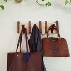 Wooden piano key wall coat rack with fold-down hooks