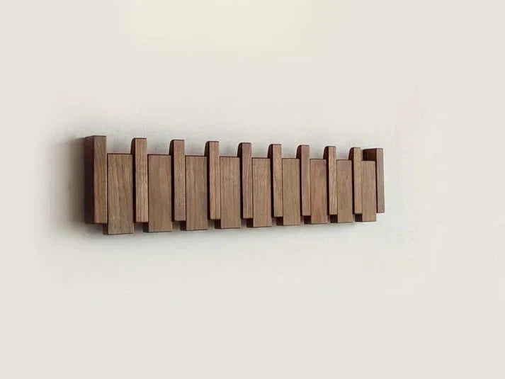 Wooden piano key wall coat rack with fold-down hooks
